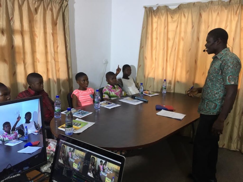 PoP's 'make-shift' classroom in the conference room where a teacher leads the five students in a lesson. (Photo credit: PoP Ghana team)